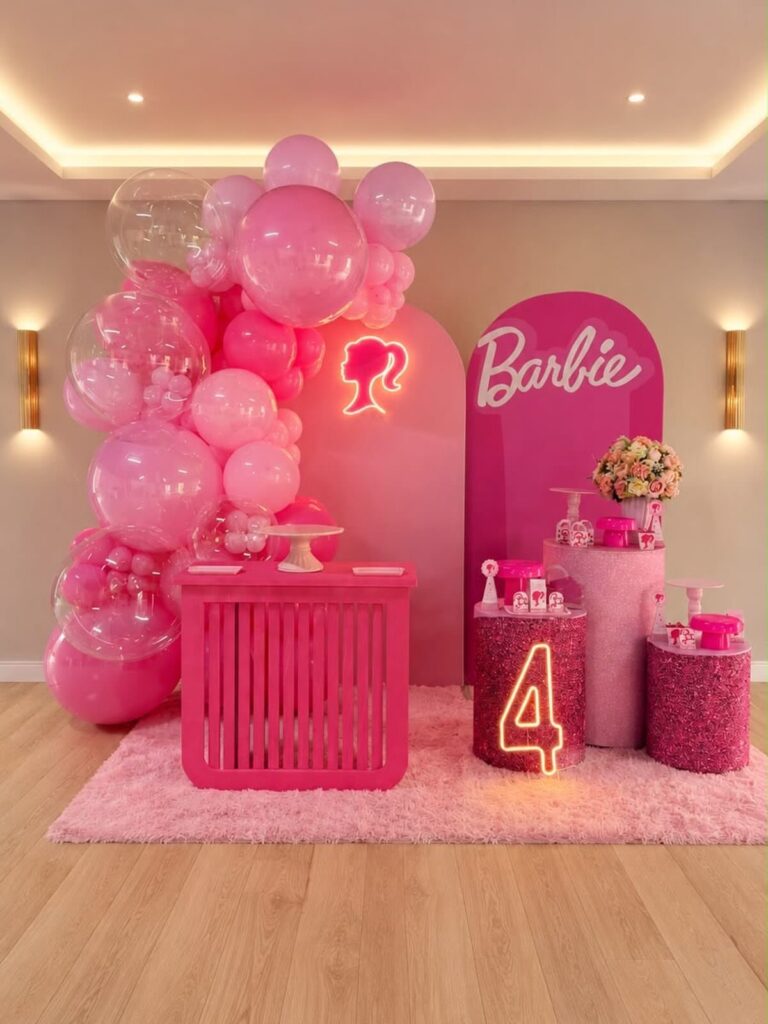Pink Barbie birthday party setup with balloons, neon signs, and dessert pedestals.