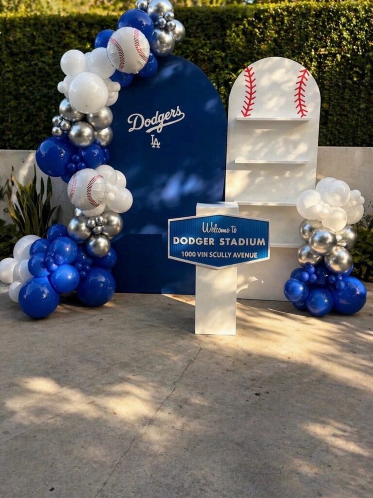 Baseball themed party decor with blue and white balloons and Dodger Stadium signage.